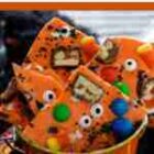 Permalink to Boo Bark A bowl filled with orange Halloween-themed treats. The treats are decorated with candy eyes, colorful candies, and bits of chocolate, topped with Halloween-themed sprinkles.