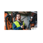 Permalink to More youth with developmental disabilities get help finding work A worker in a yellow safety vest stands confidently in an industrial setting with machinery in the background. The logo for British Columbia is in the bottom right corner.